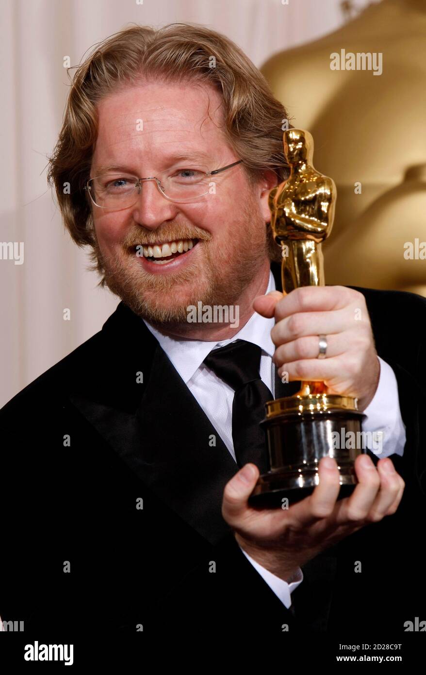 Andrew Stanton poses with his Oscar for best animated feature with the film  
