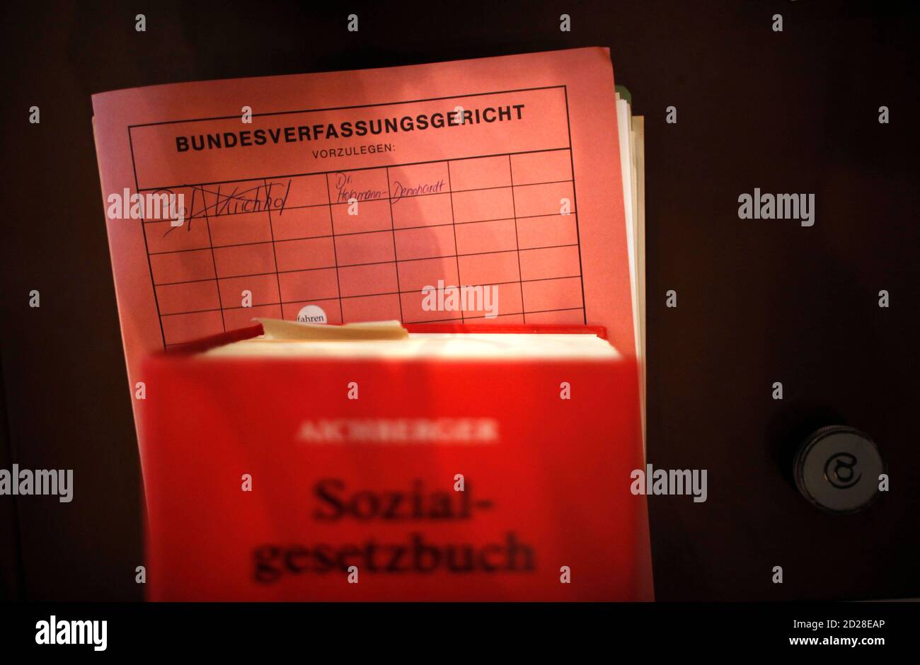 A social code book of German law (sozialgesetzbuch) and constitutional court files are pictured before a hearing about child allowances included in Hartz IV national unemployment benefits, at a court in Karlsruhe October 20, 2009. REUTERS/Johannes Eisele  (GERMANY CRIME LAW POLITICS IMAGES OF THE DAY) Stock Photo