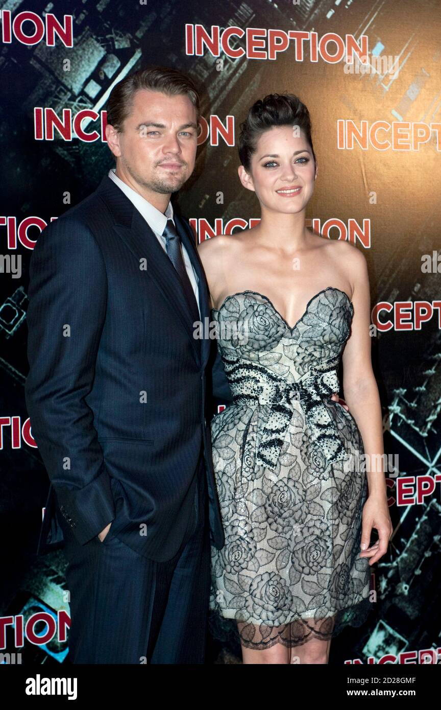 Actors Leonardo DiCaprio and Marion Cotillard pose as they arrive for the premiere of the film
