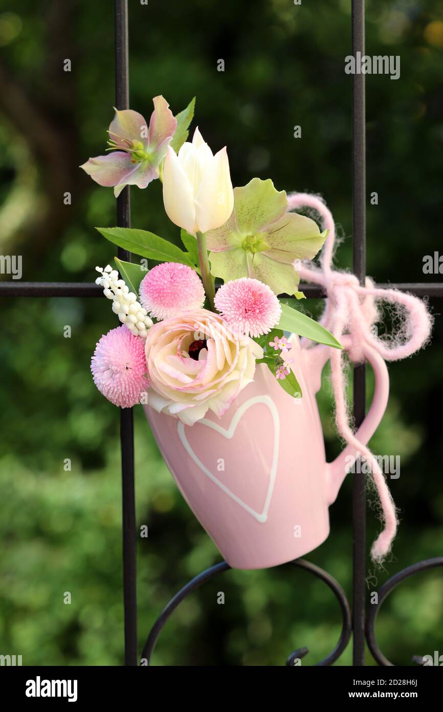 romantic bouquet of white and pink spring flowers in cup Stock Photo