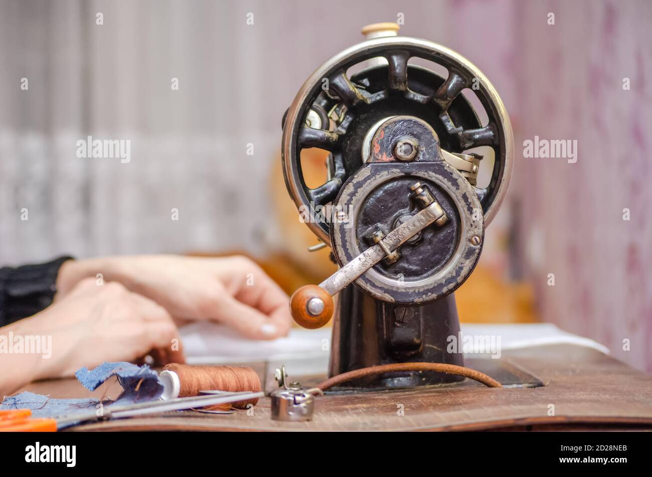Woman working on an old sewing machine. Hands close-up Stock Photo - Alamy