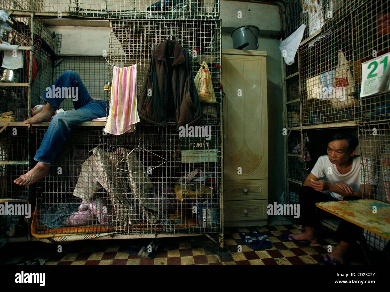 People rest at one of about 100 cage homes in Hong Kong March 20, 2009. The  monthly rent of a caged-bed, the lowest standard for a shelter in Hong Kong  besides sleeping