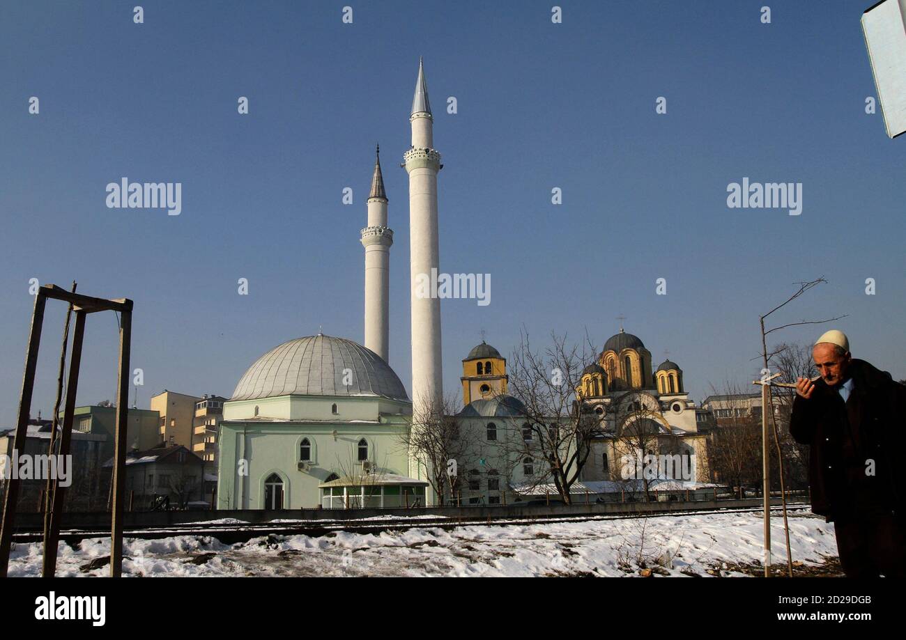 A Kosovo Albanian Man Walks Near A Mosque L And A Serbian Orthodox Church In The