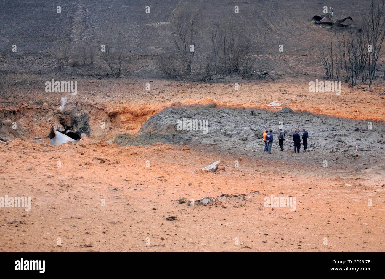 Police and gas industry officials examine the ash-covered scene of an  accident caused by an explosion on a pipeline near the Ukrainian village of  Luka, 156 km (97 miles) south of the
