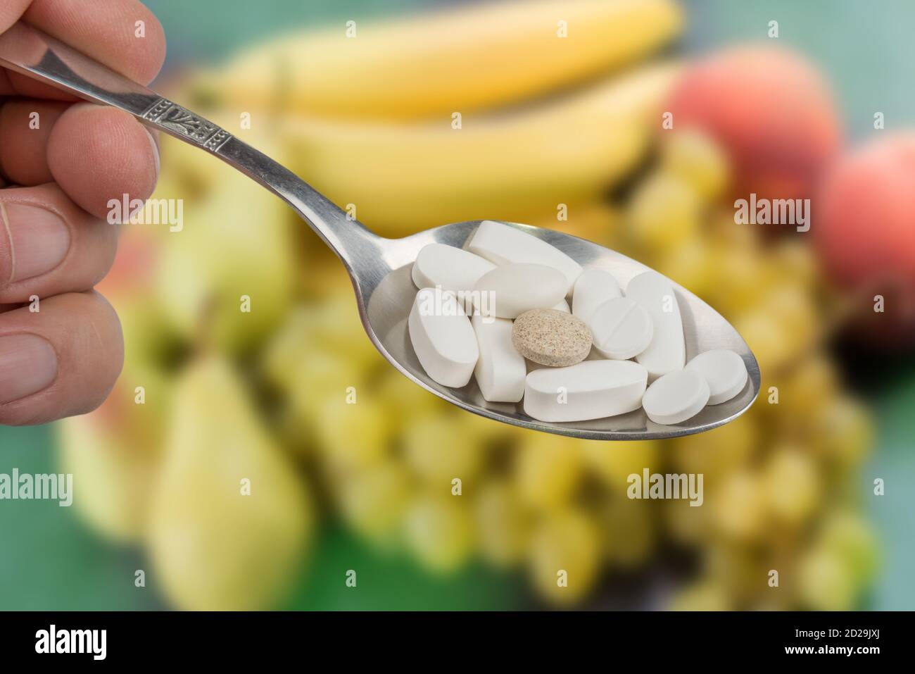 Pills versus fruit. Vitamins in fruits are better than pill Stock Photo