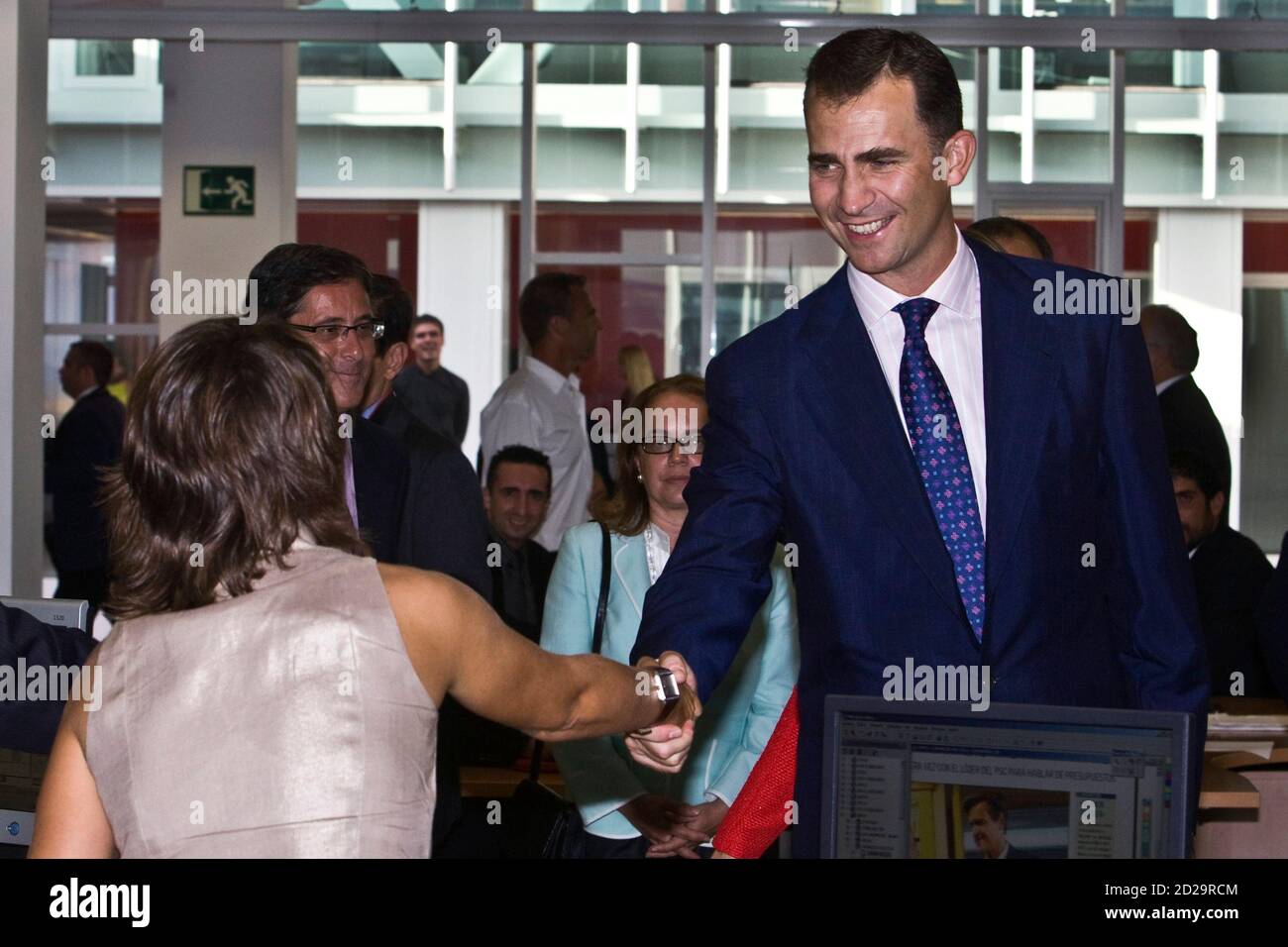 Spain's Crown Prince Felipe shakes hands with a journalist during the  inauguration of a new building for the "Canarias 7" newspaper in Las Palmas  de Gran Canaria, Canary islands October 13, 2008.