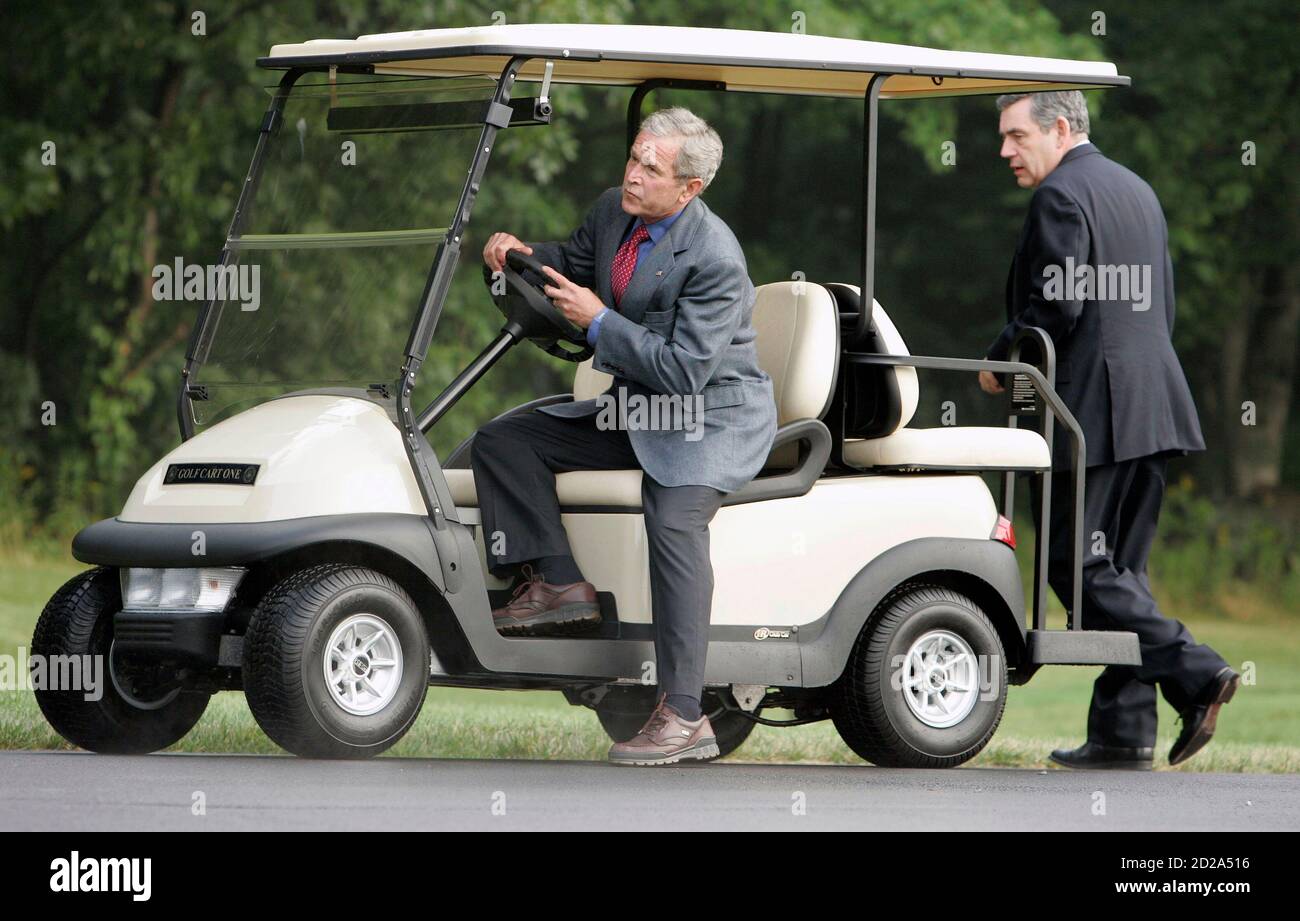 U.S. President George W. Bush gives a ride in a golf cart to British Prime  Minister Gordon Brown at Camp David, outside of Thurmont, Maryland, July  29, 2007. REUTERS/Larry Downing (UNITED STATES