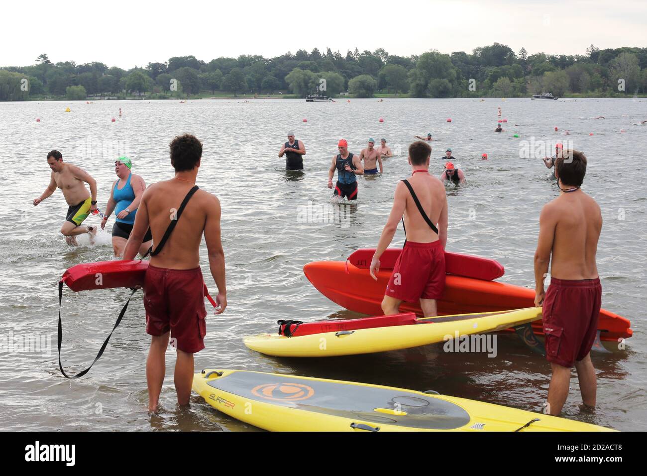 Lifeguards watch as swimmers emerge from the water at the Lifetime Fitness Triathlon in Minneapolis, Minnesota. Stock Photo