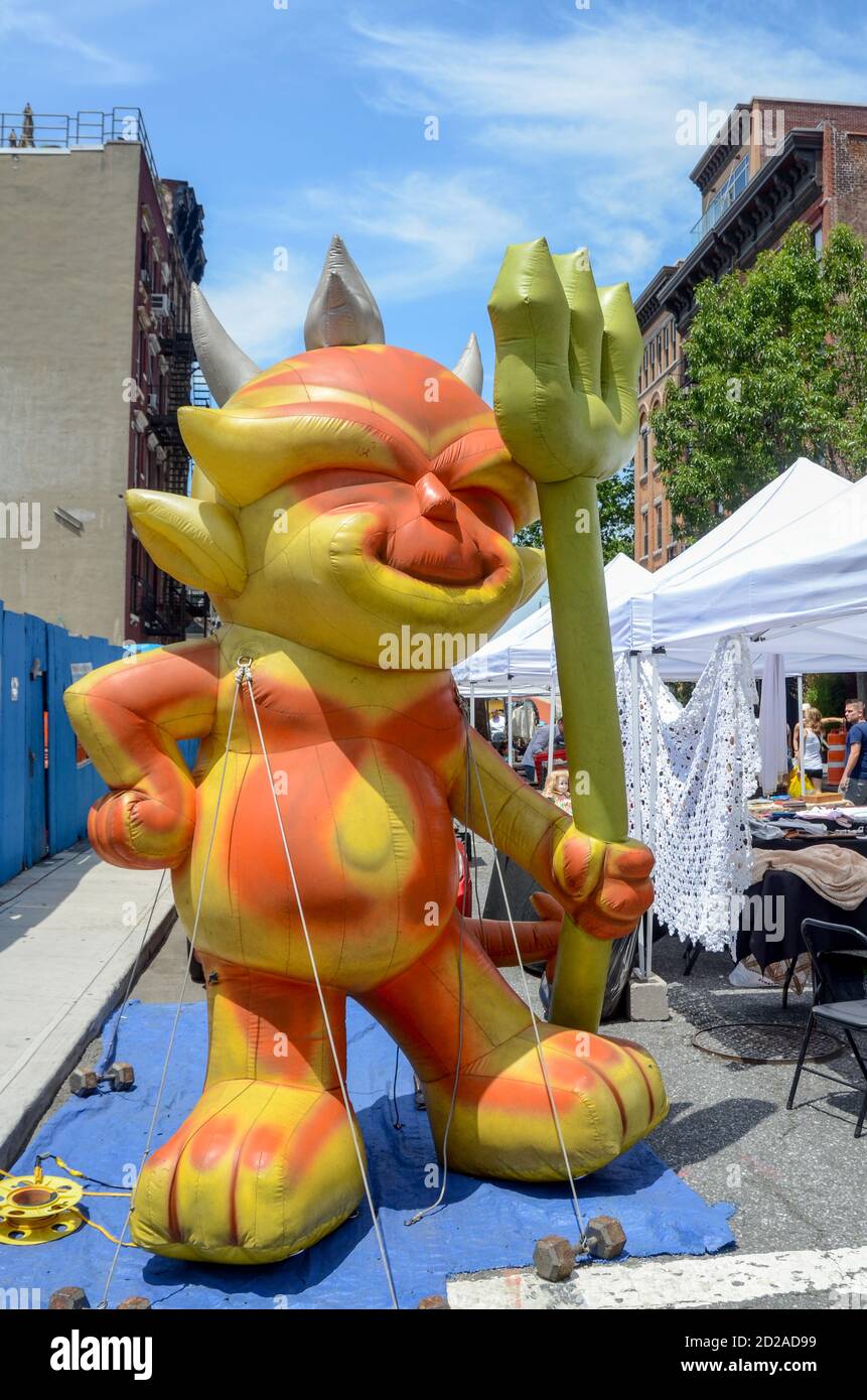 An inflated devil meets one at the entrance to the Hell's Kitchen Flea Market. Photo by Liz Roll Stock Photo