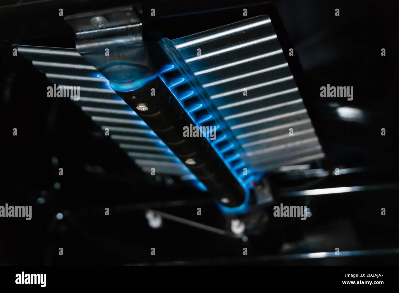 Blue flames burning inside a gas oven close up Stock Photo Alamy