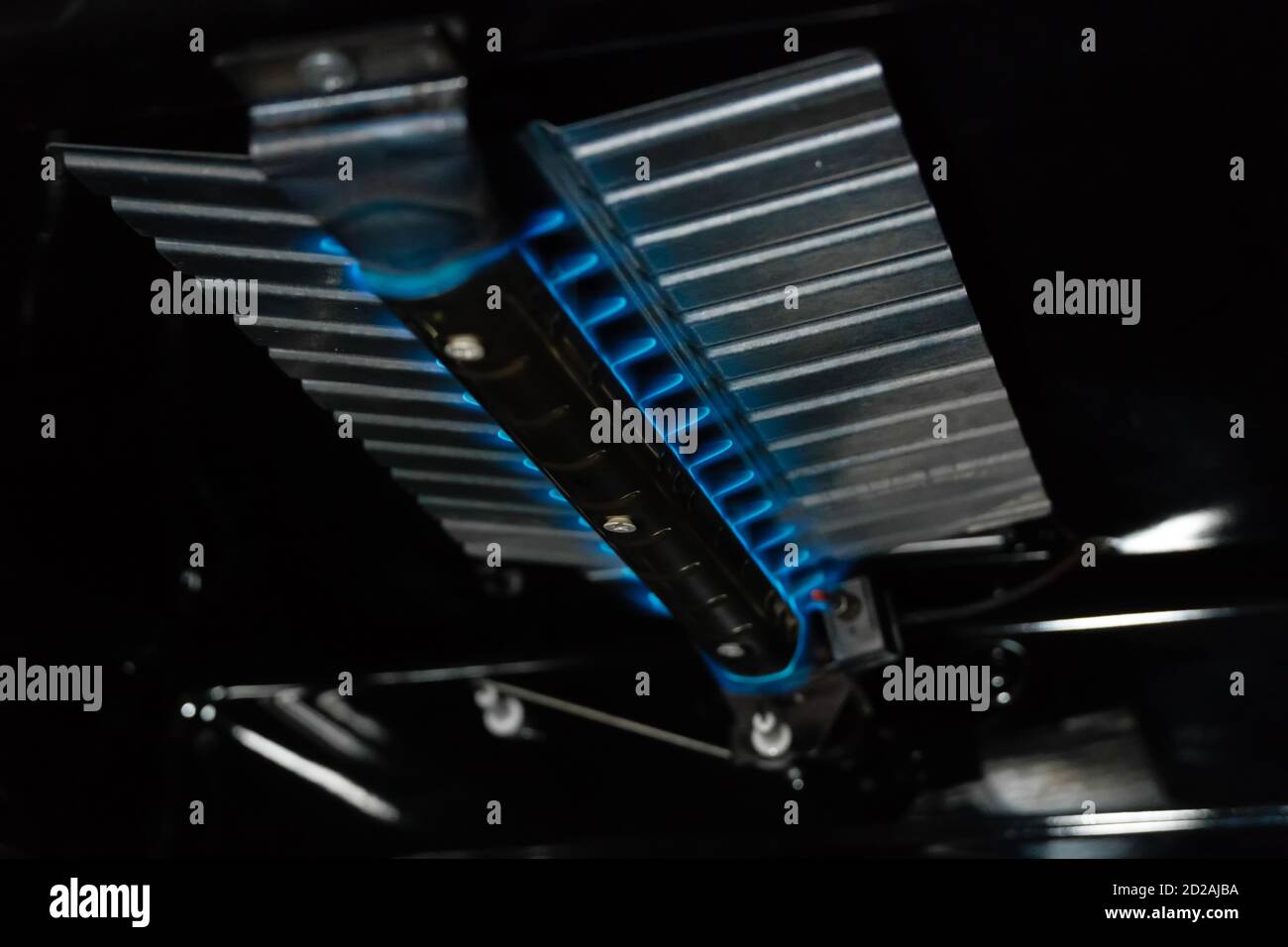 Blue flames burning inside a gas oven close up Stock Photo Alamy