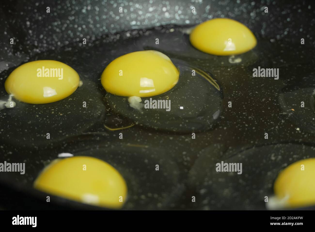 Six eggs frying in a pan close up Stock Photo