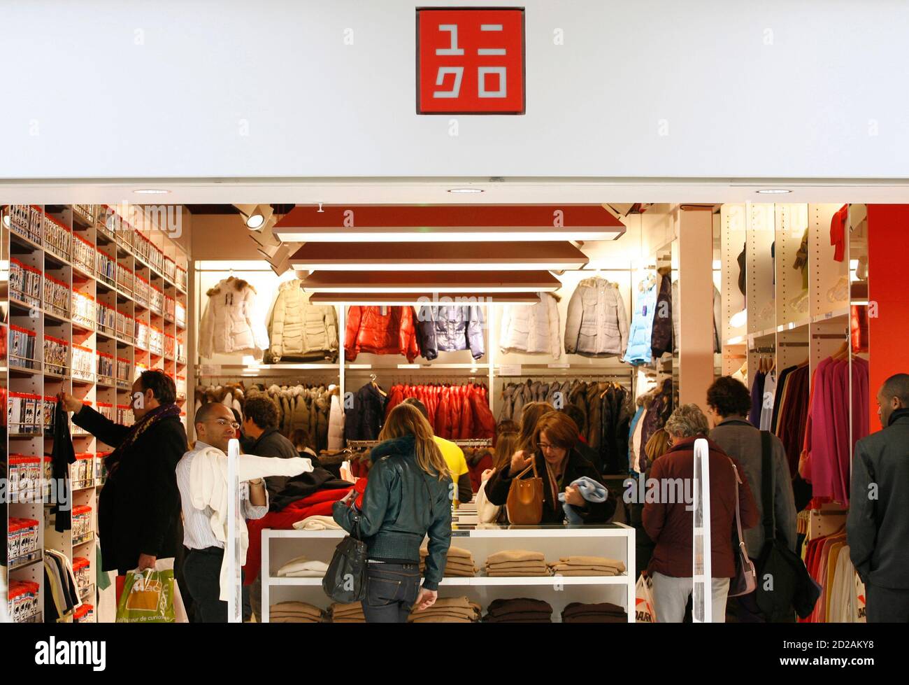 Customers look at clothes inside the casual clothing store Uniqlo operated  by Japanese clothing retailer Fast Retailing Co. in La Defense, near Paris  December 21, 2007. Fast Retailing Co. opened its first