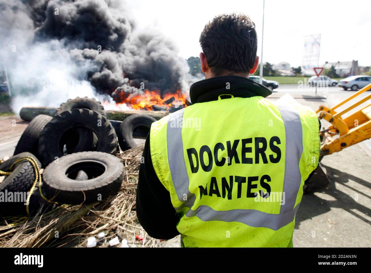 Dockers set up a barricade with burning tyres during a protest rally at the  port of Nantes-Saint-Nazaire, western France, on April 23, 2008. A 24-hour  strike by workers in France's seven state-run