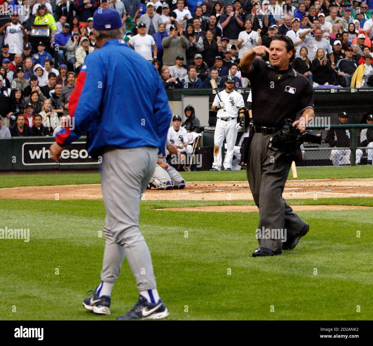 Home plate umpire Rob Drake (R) gestures as he throws out Chicago Cubs  manager Lou Piniella from the game in the second inning of their MLB  interleague baseball game against the Chicago