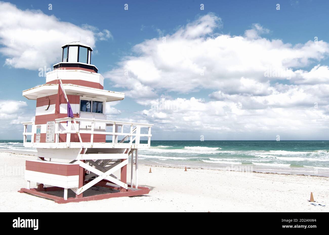 Miami, South Beach, Florida, lifeguard house in a typical colorful Art Deco style on cloudy day with blue sky and Atlantic Ocean in background, world famous travel location Stock Photo