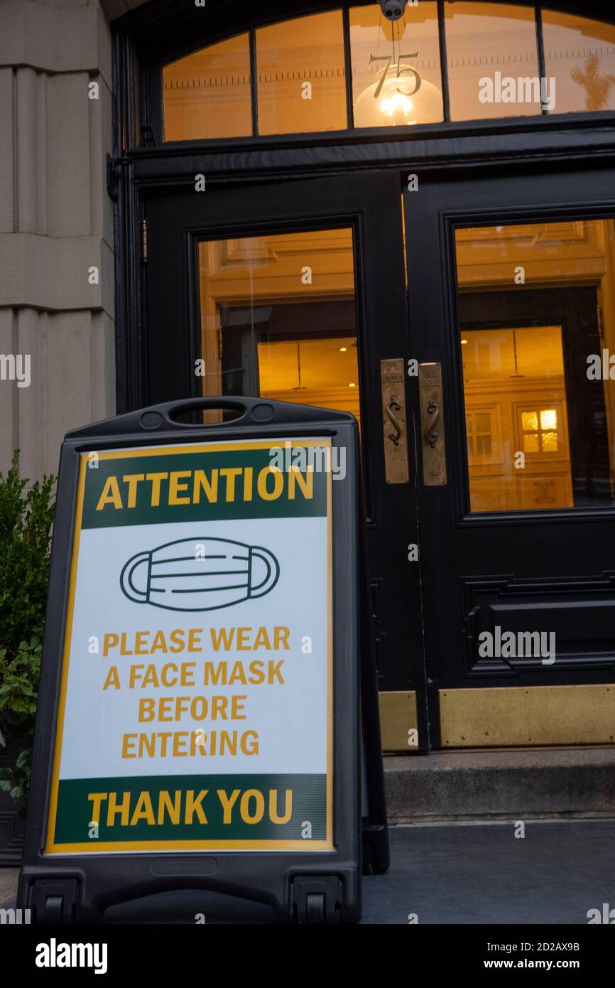 Covid 19 wear a mask rules in front of a business in Brooklyn NYC Stock Photo