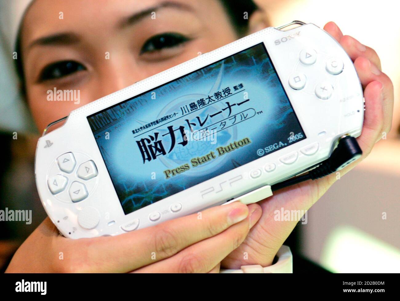 A model shows the Sony Computer Entertainment's new colour PlayStation  Portable (PSP) at Tokyo Game Show 2005, Japan's biggest video game software  exhibition, at Makuhari Messe Convention Centre in Chiba, east of
