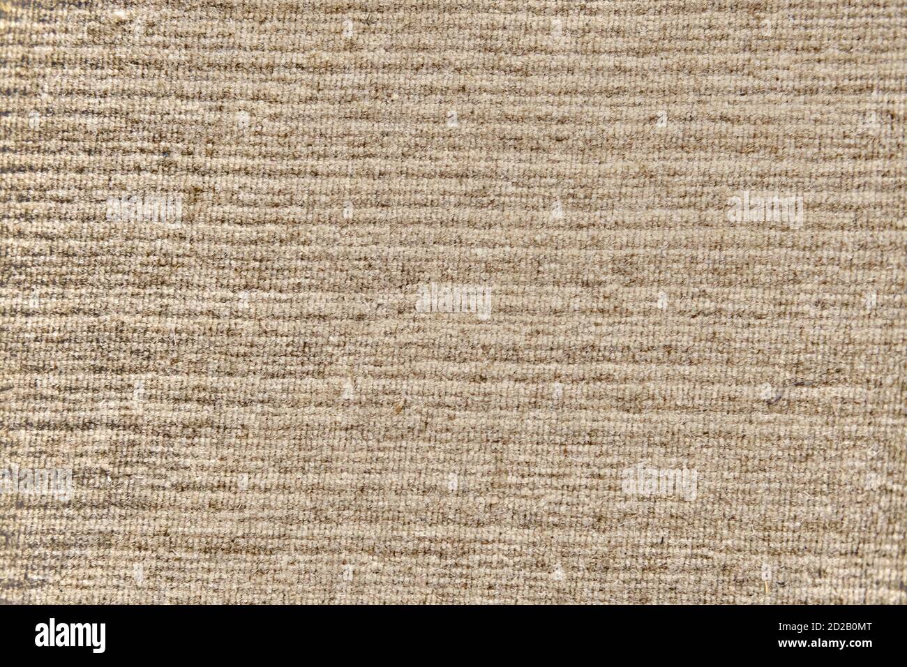 Texture of an old worn carpet, background with a beige pattern Stock