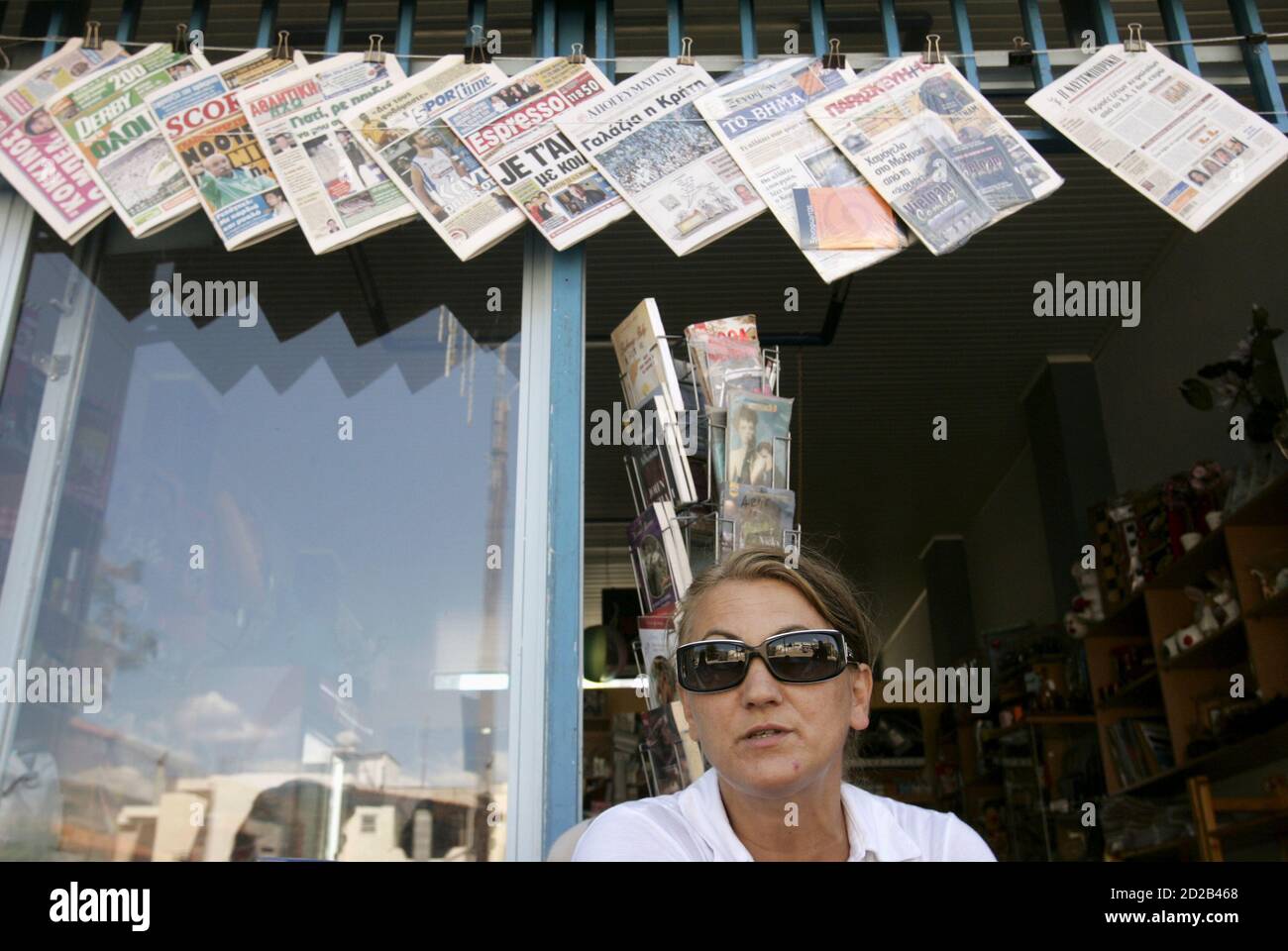 Shop owner Christina Bakou, 41, sits in front of her shop in the town of Kirra in central Greece, some 200km (124 miles) west of Athens, September 11, 2007. Days before a closely fought Greek election, a deep political divide has gripped the town of Kirra, which correctly predicted the result of the last parliamentary vote. Picture taken September 11, 2007. REUTERS/Yiorgos Karahalis  (GREECE) Stock Photo