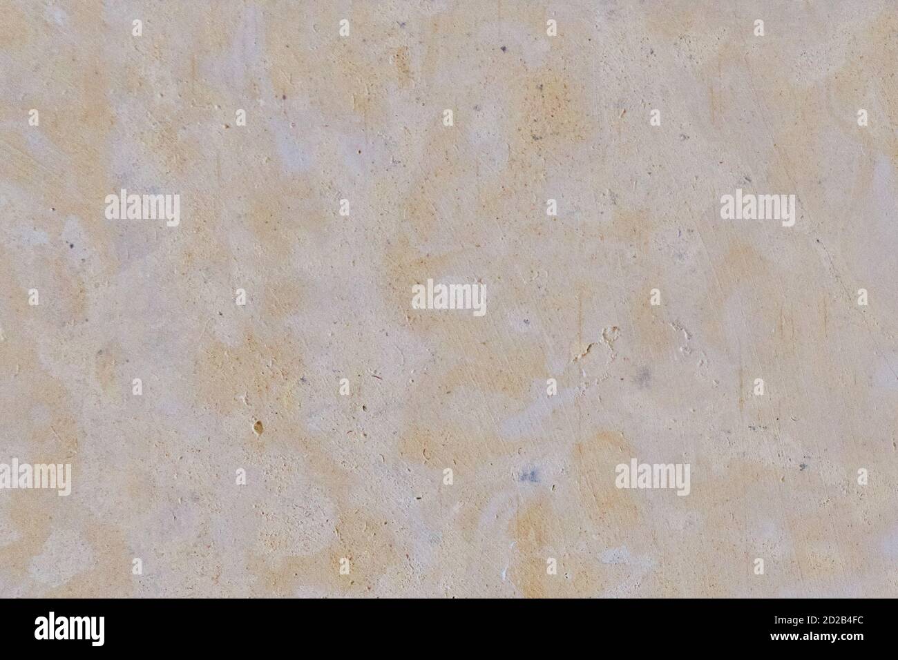 Texture of porous limestone stone of orange color. Wall background with