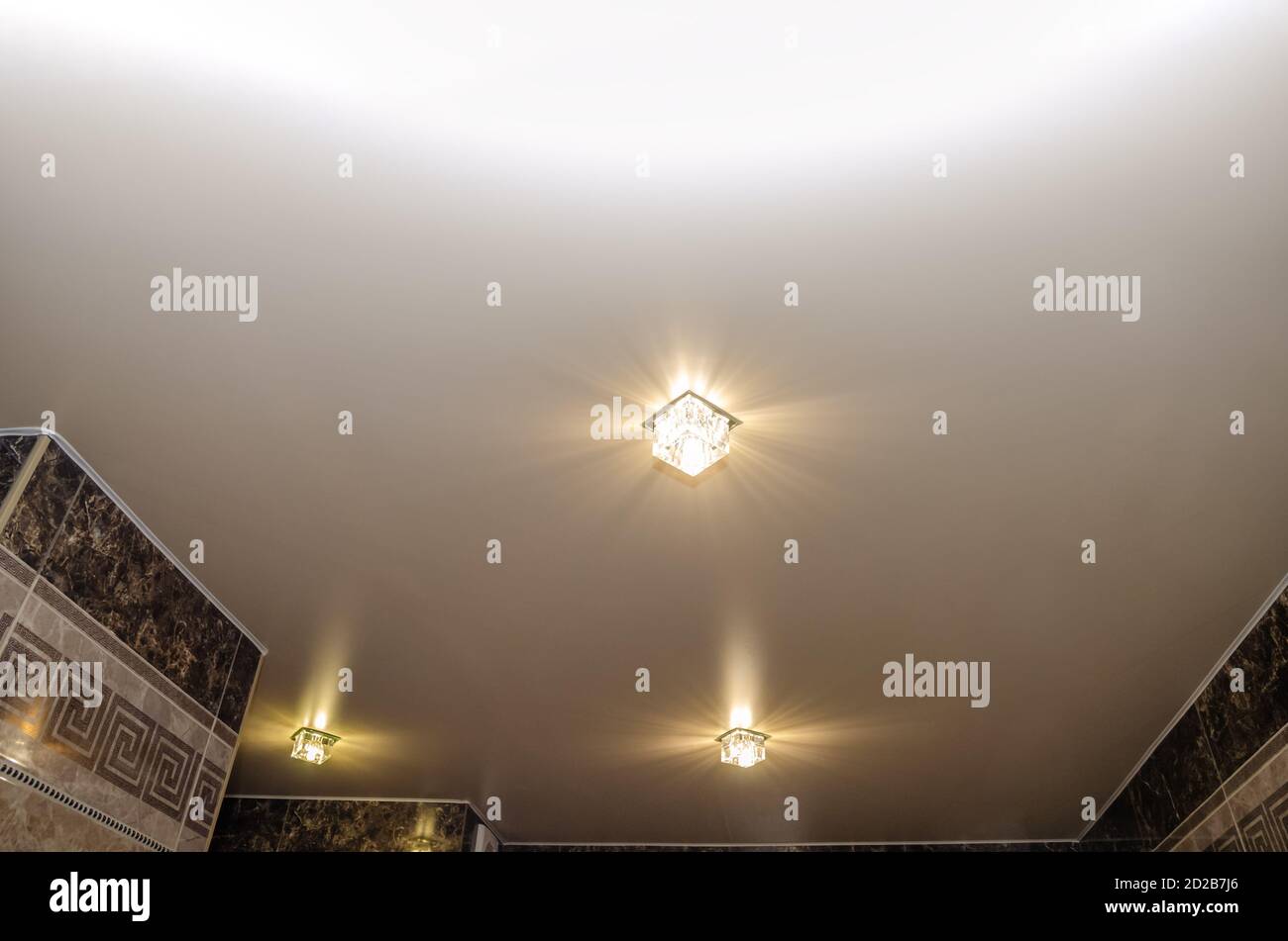 Stretch ceiling in the bathroom with three spotlights Stock Photo