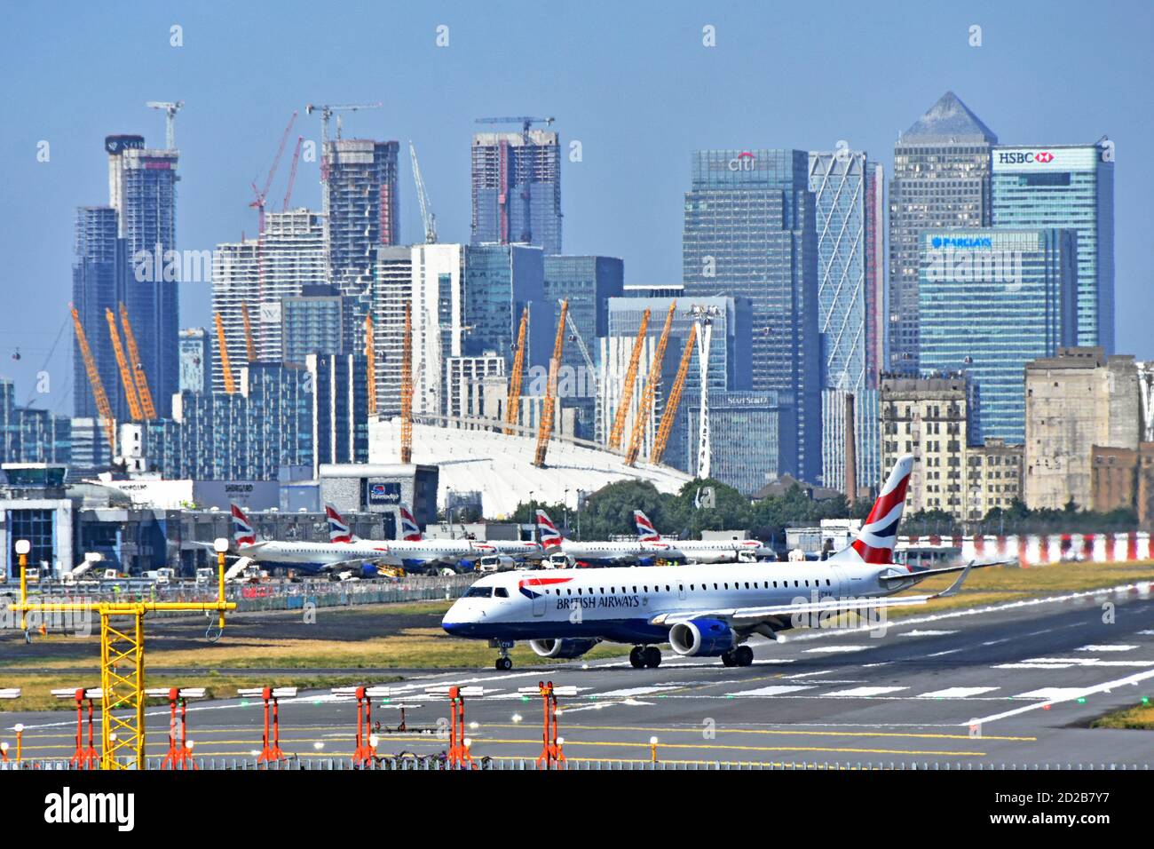 British Airways plane turning at London City Airport runway for taking off for business travel from Canary Wharf East London Docklands England UK Stock Photo