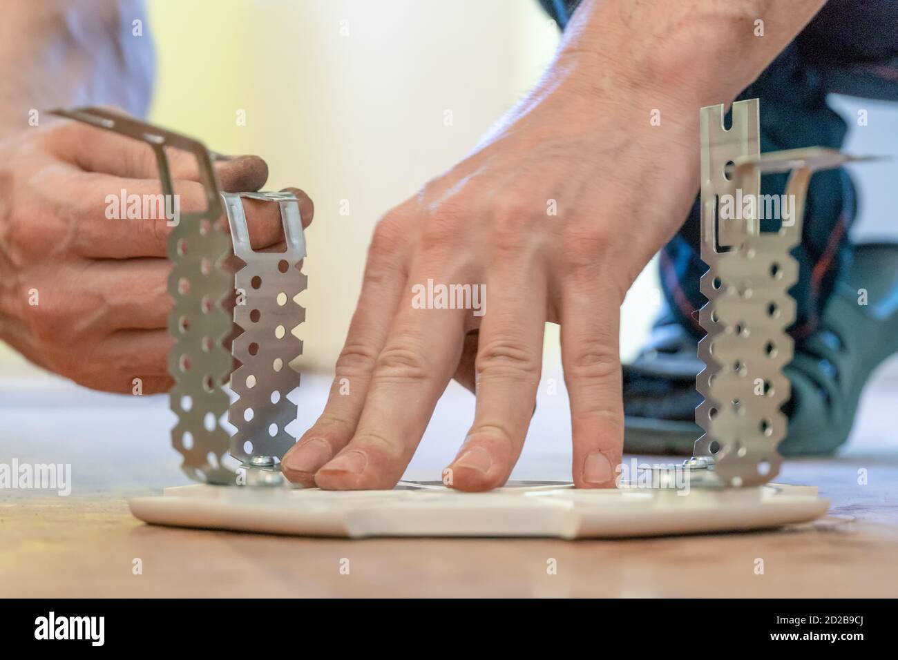 Preparing the platform for a lamp for a stretch ceiling close-up Stock Photo