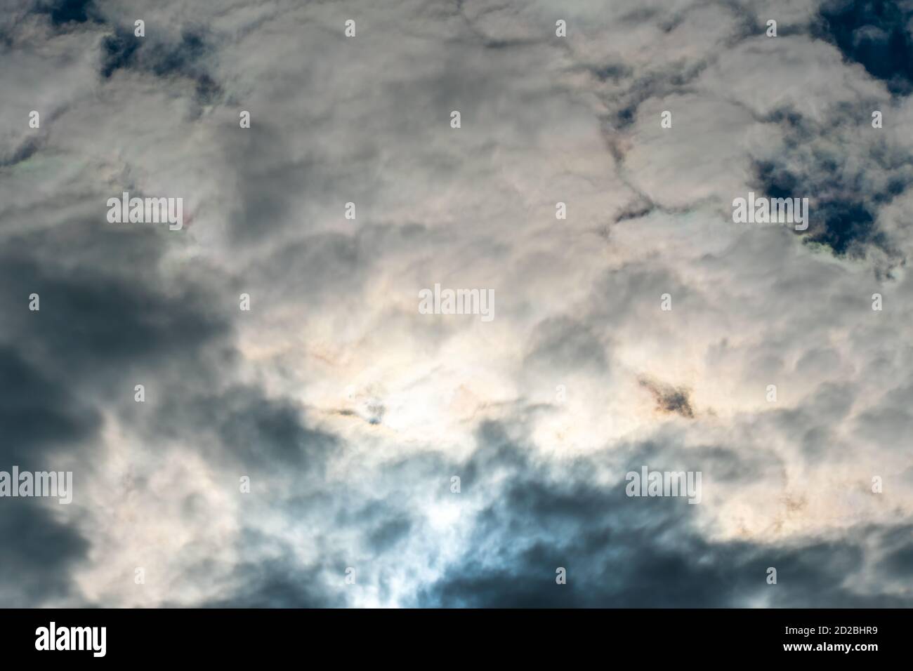 Sky with dark clouds and sun, beautiful background Stock Photo