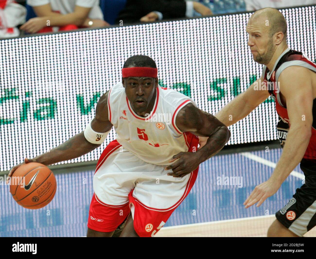 Ansu Sesay (L) of Armani Jeans Milano dribbles past Kenan Bajramovic of  Lietuvos Rytas during their Euroleague Group B men's basketball game in  Vilnius December 12, 2007. REUTERS/Ints Kalnins(LITHUANIA Stock Photo -
