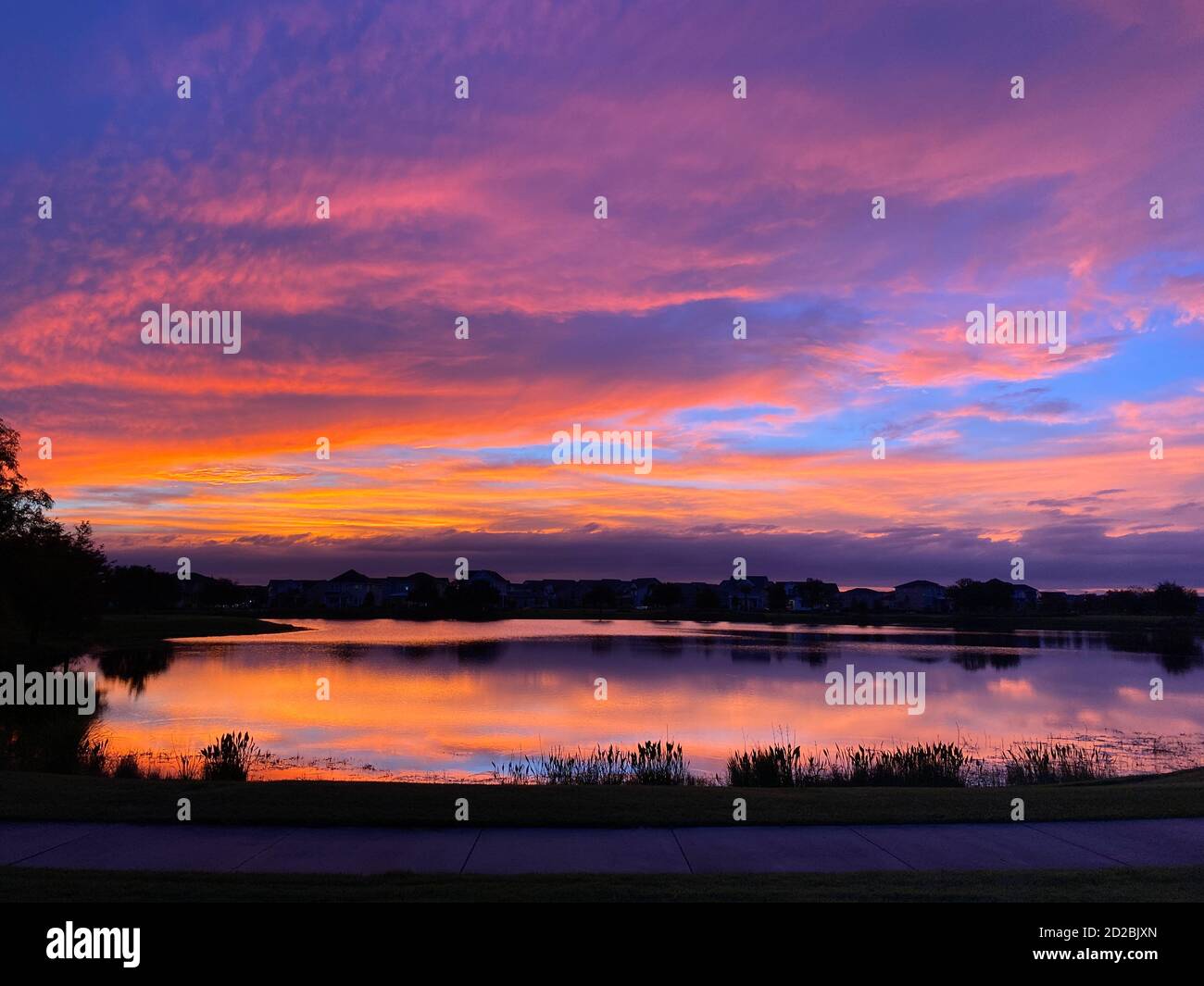 Beautiful pink, orange and blue sunset reflecting on a lake in a ...