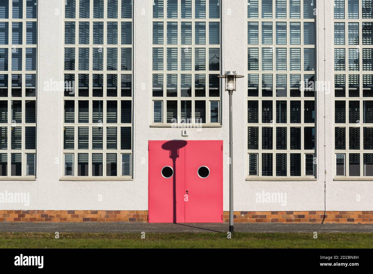 Two-leaf red door with the portholes and the street lamp Stock Photo