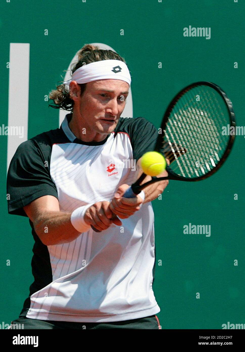 Juan Carlos Ferrero of Spain returns the ball to Nicolas Massu of Chile  during their match in the Monte Carlo Masters Series tennis tournament in  Monaco April 18, 2007. REUTERS/Pascal Deschamps (MONACO