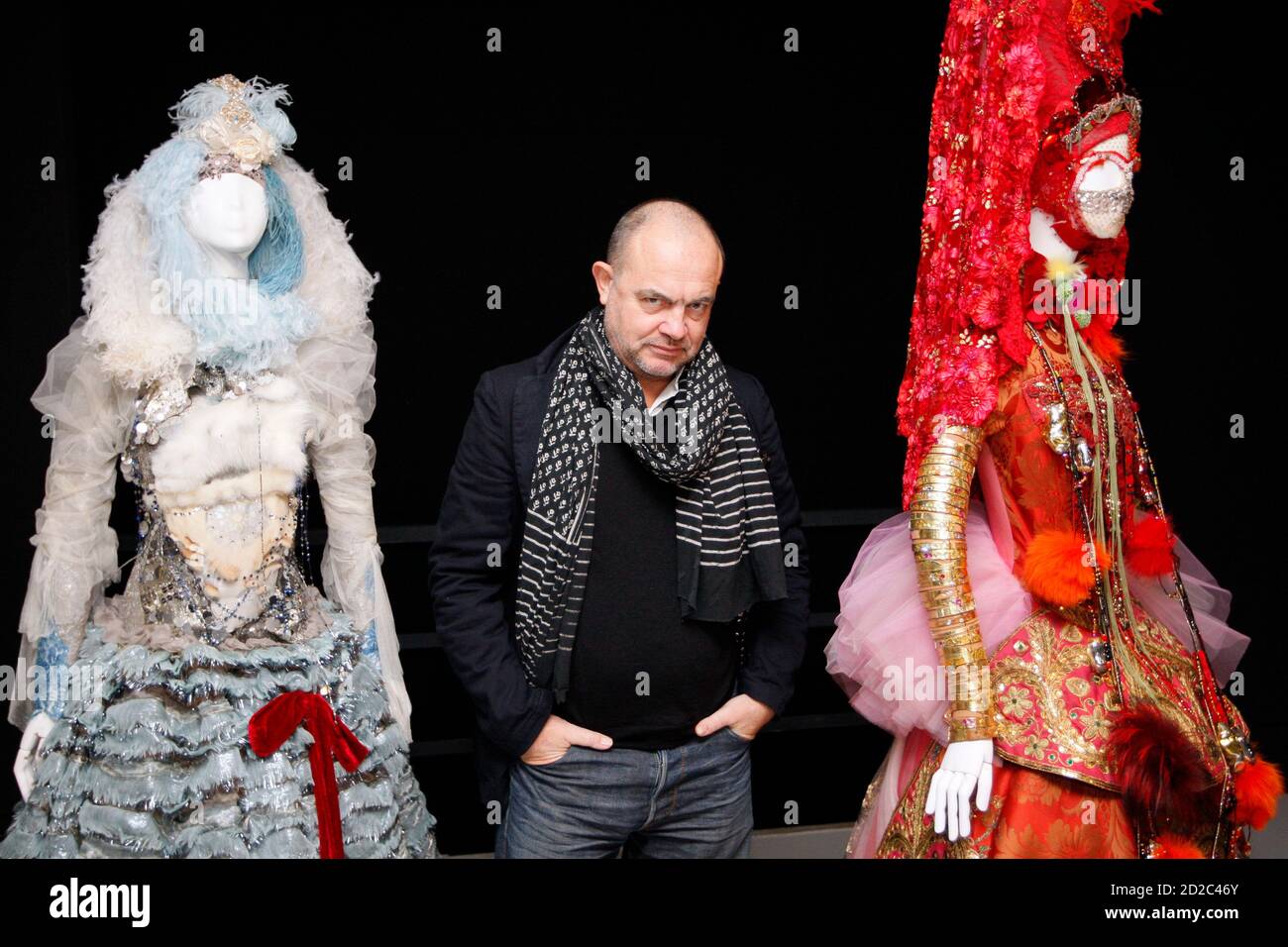 France's fashion designer Christian Lacroix poses for the media next to one  of his creations for the opening of the exhibition "Christian Lacroix,  Histoires de Mode" at the Arts Decoratifs museum in