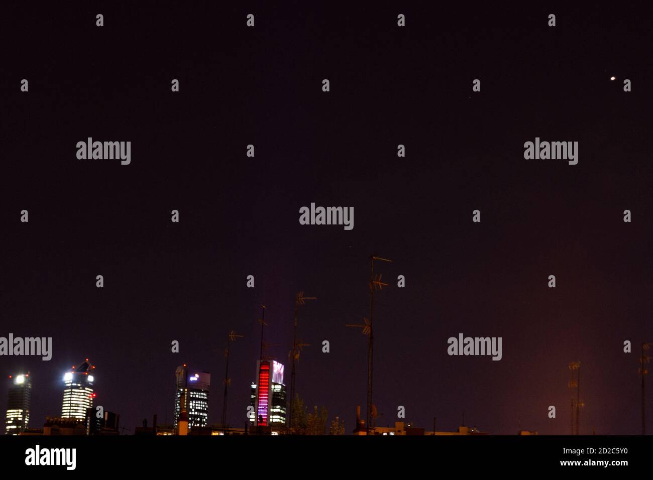 The planet Mars seen from the Community of Madrid and the skyscrapers of Madrid with the 4 towers, in Spain. Stock Photo