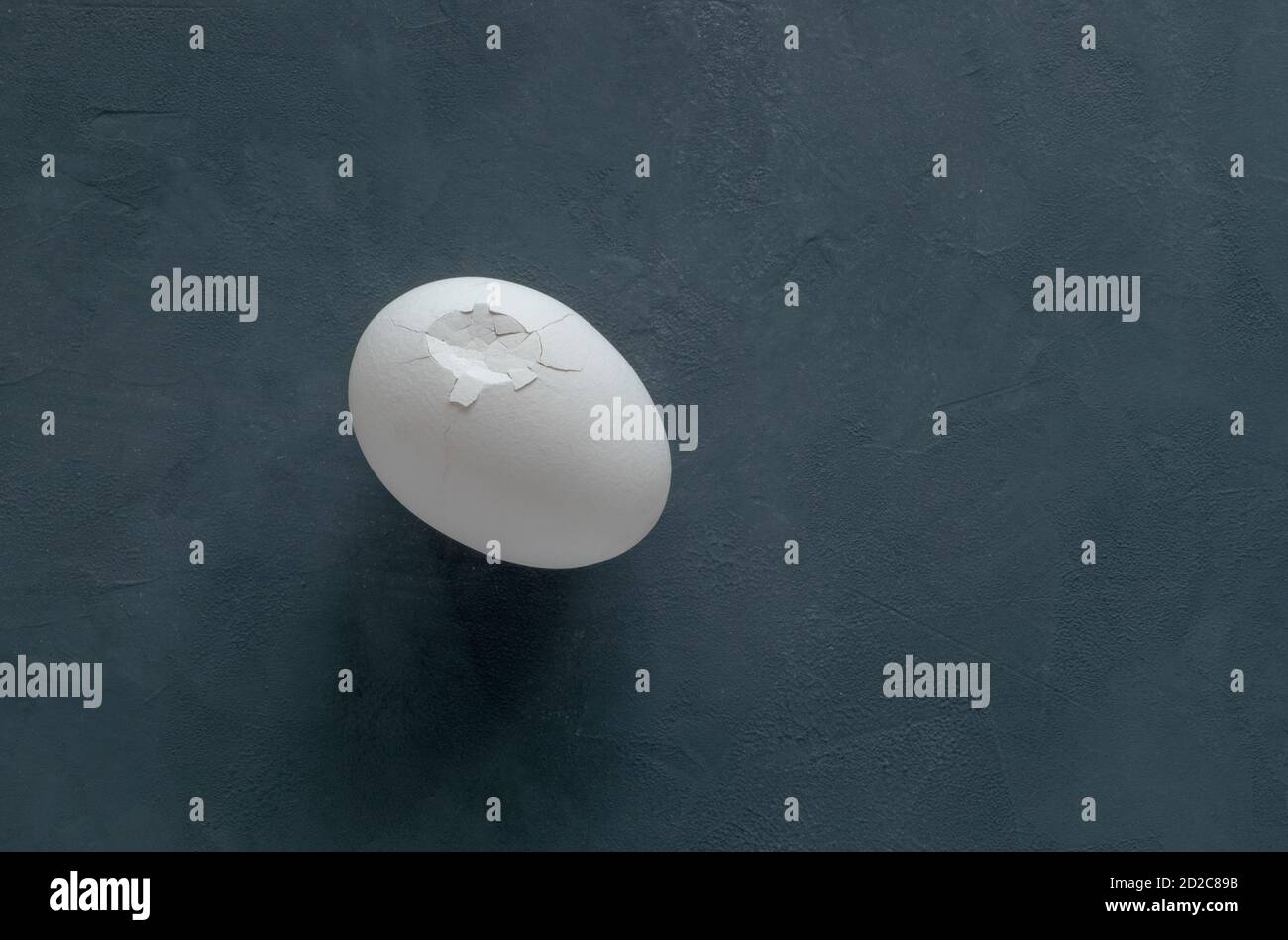 White broken chicken egg on a black background Stock Photo