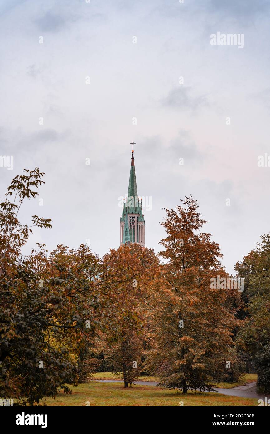 Catholic church tower seen from a park. Archcathedral Basilica of St
