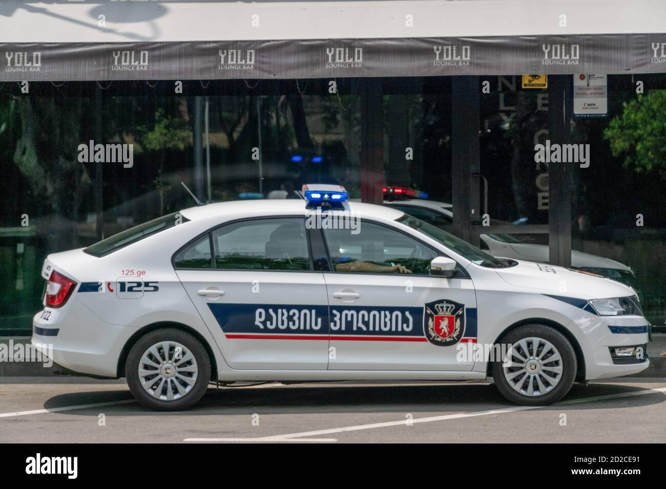 Tbilisi, Georgia - June 27 2019: Police car on an asphalt road against the mountains on a sunny clear day Stock Photo