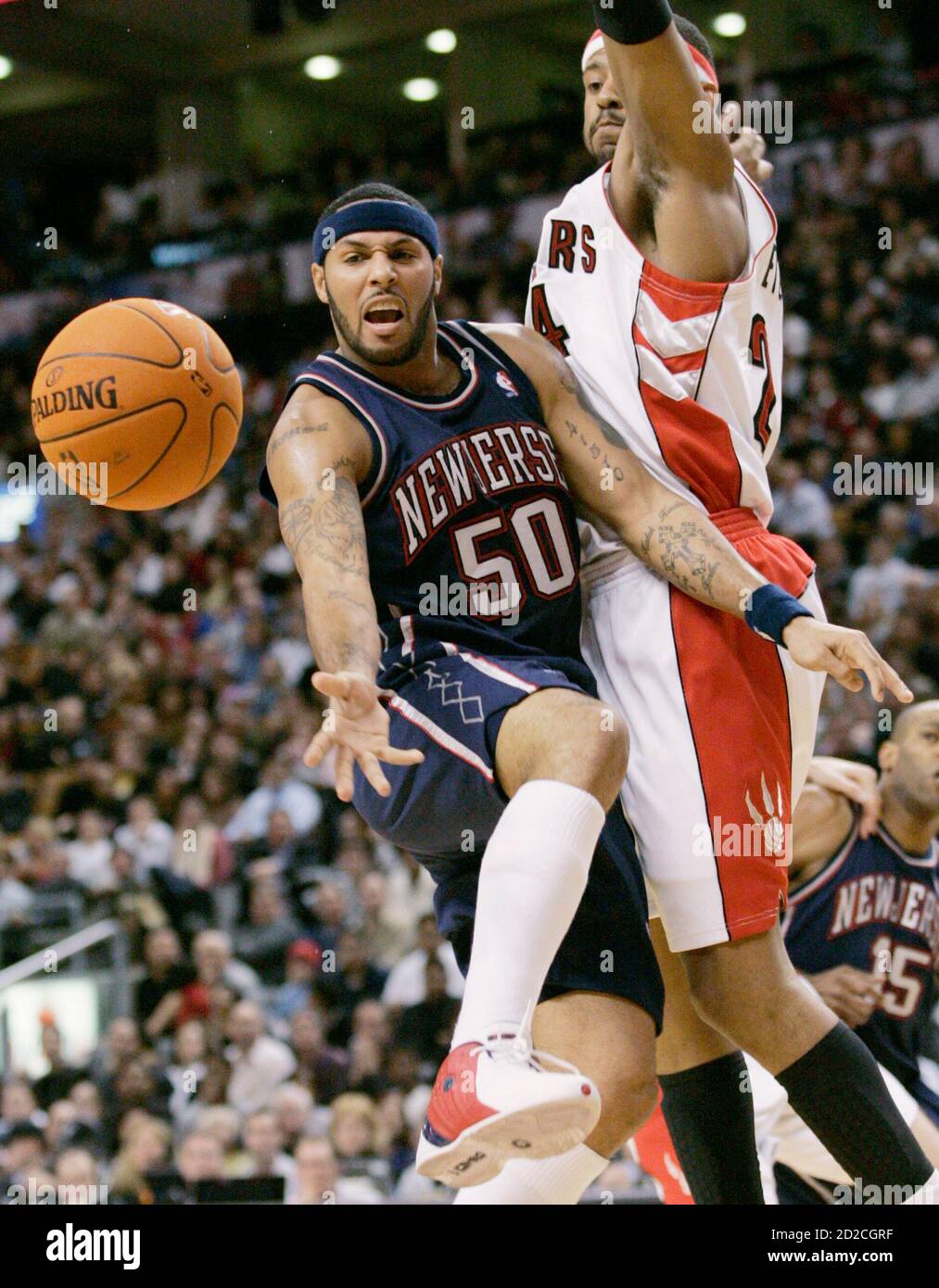 New Jersey Nets guard Eddie House (50) passes off the ball while being  blocked by Toronto Raptors' Morris Peterson (R) during the second half of  their NBA basketball game in Toronto December