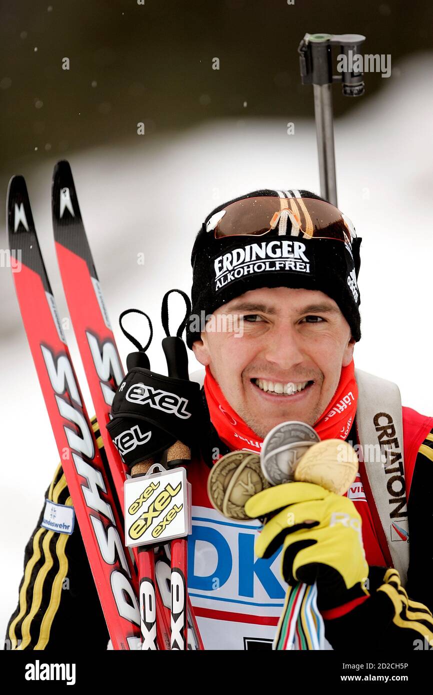 World Champion Michael Greis of Germany shows three medals he had won  during the Biathlon World Championship in the northern Italy ski resort of  Anterselva February 11, 2007. REUTERS/Alessandro Bianchi (ITALY Stock