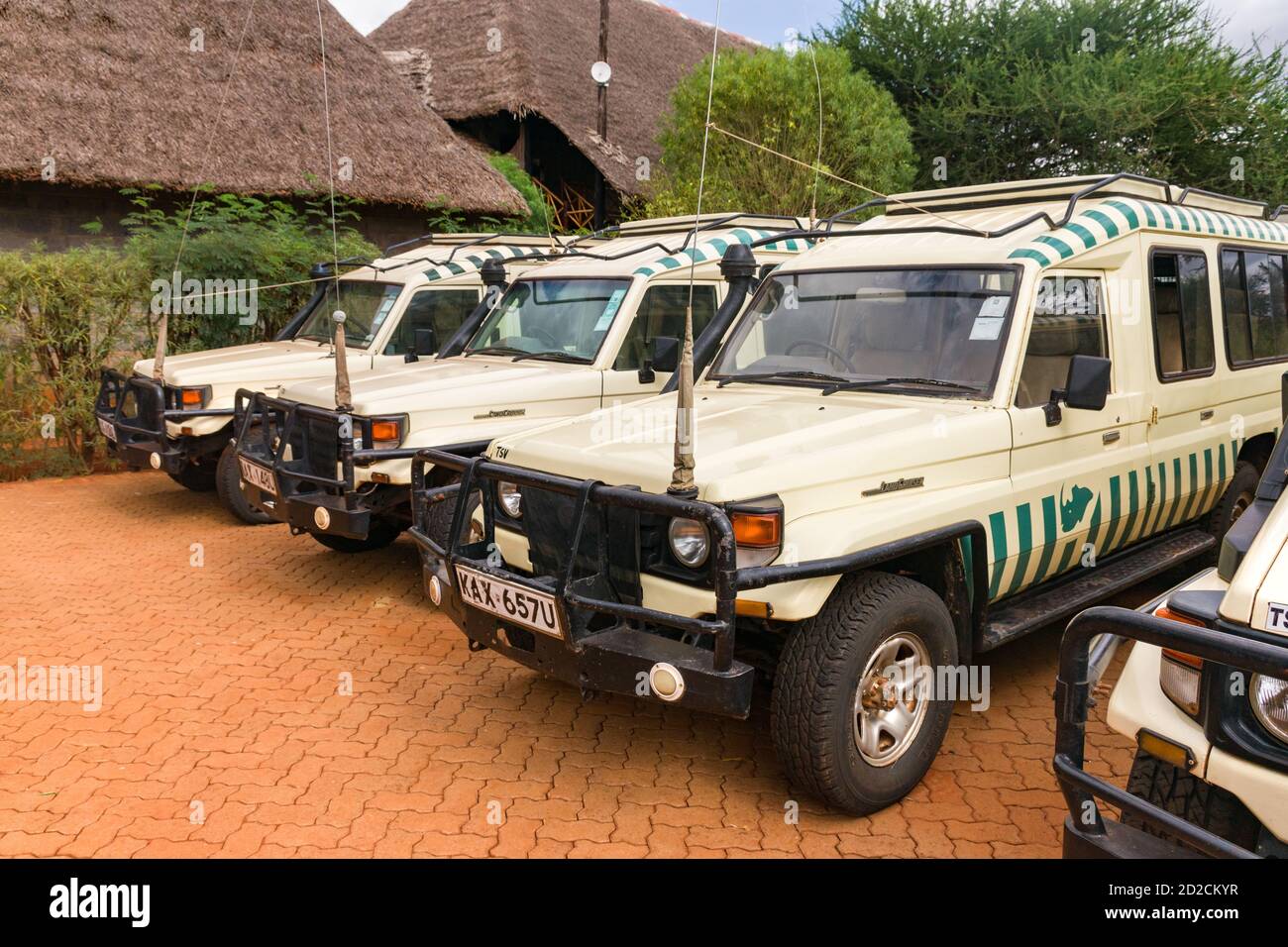 Several empty Toyota Landcruiser 4x4 offroad safari vehicles parked at a game lodge due to lack of tourists, Kenya, East Africa Stock Photo
