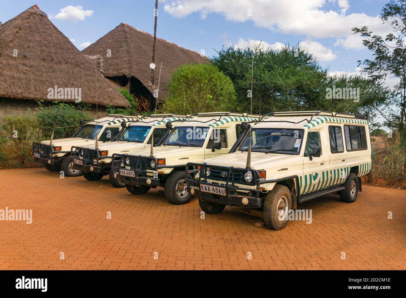 Several empty Toyota Landcruiser 4x4 offroad safari vehicles parked at a game lodge due to lack of tourists, Kenya, East Africa Stock Photo