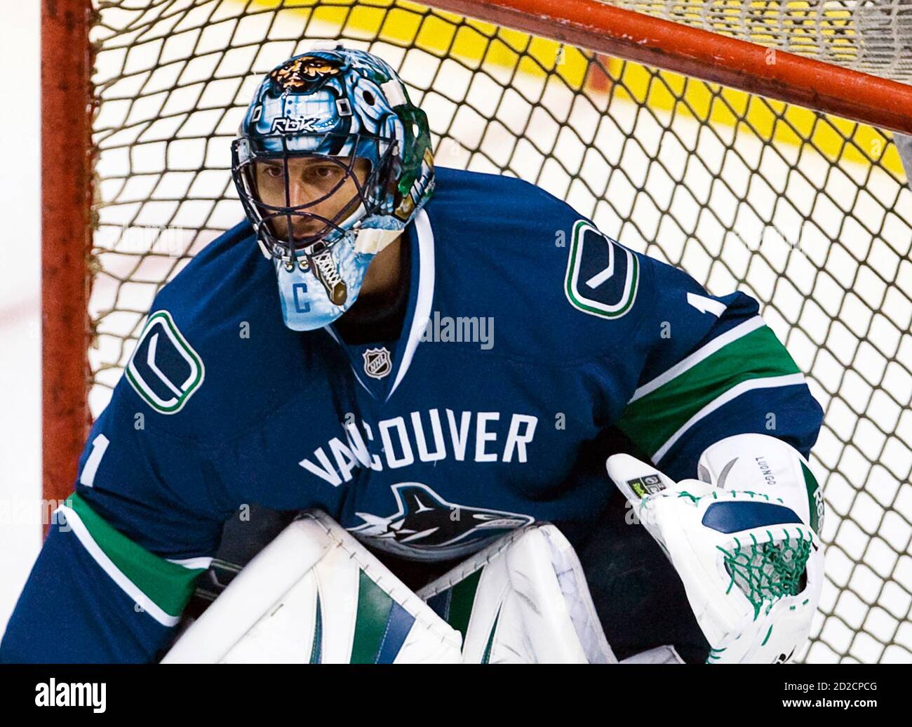 Vancouver Canucks goalie and new captain Roberto Luongo wears the "C" on  his mask during warmup before their NHL home opener against the Calgary  Flames in Vancouver, British Columbia October 9, 2008.