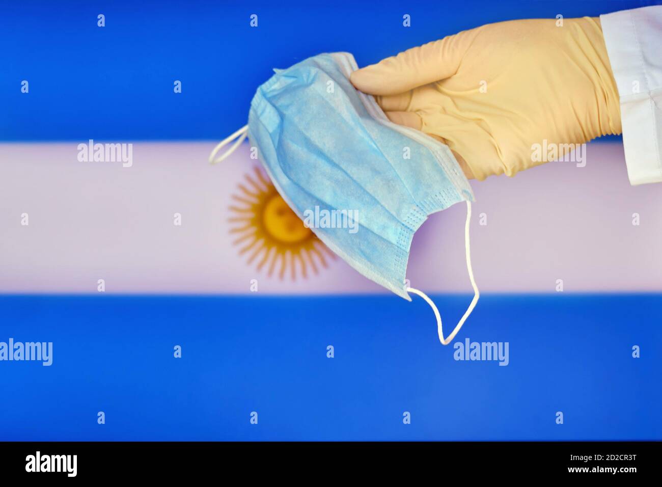 Medical mask in the hands of a doctor and the Argentina flag, copy ...