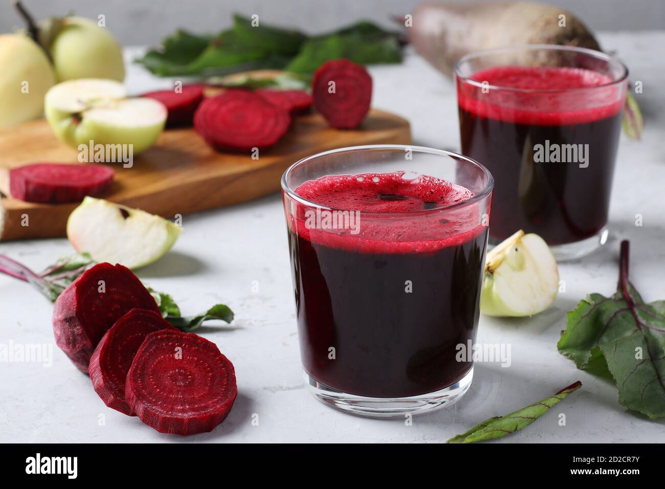 Two glass of fresh juice with beetroot and apples. Chopped beet and