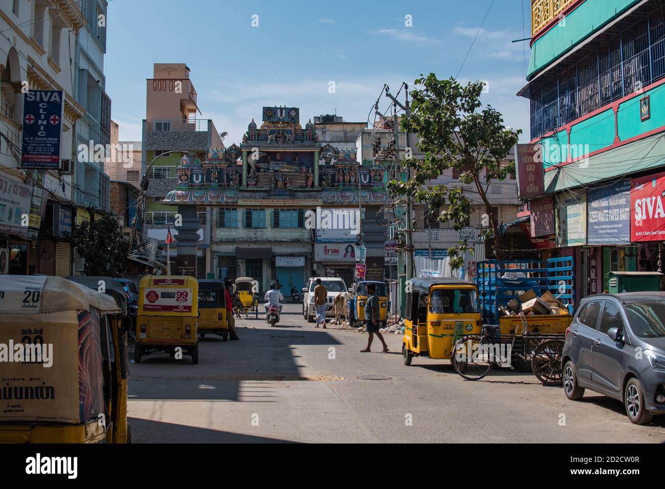 Chennai, India - February 6, 2020: Everyday life on a street with yellow auto rickshaws and unidentified people on February 6, 2020 in Chennai, India Stock Photo