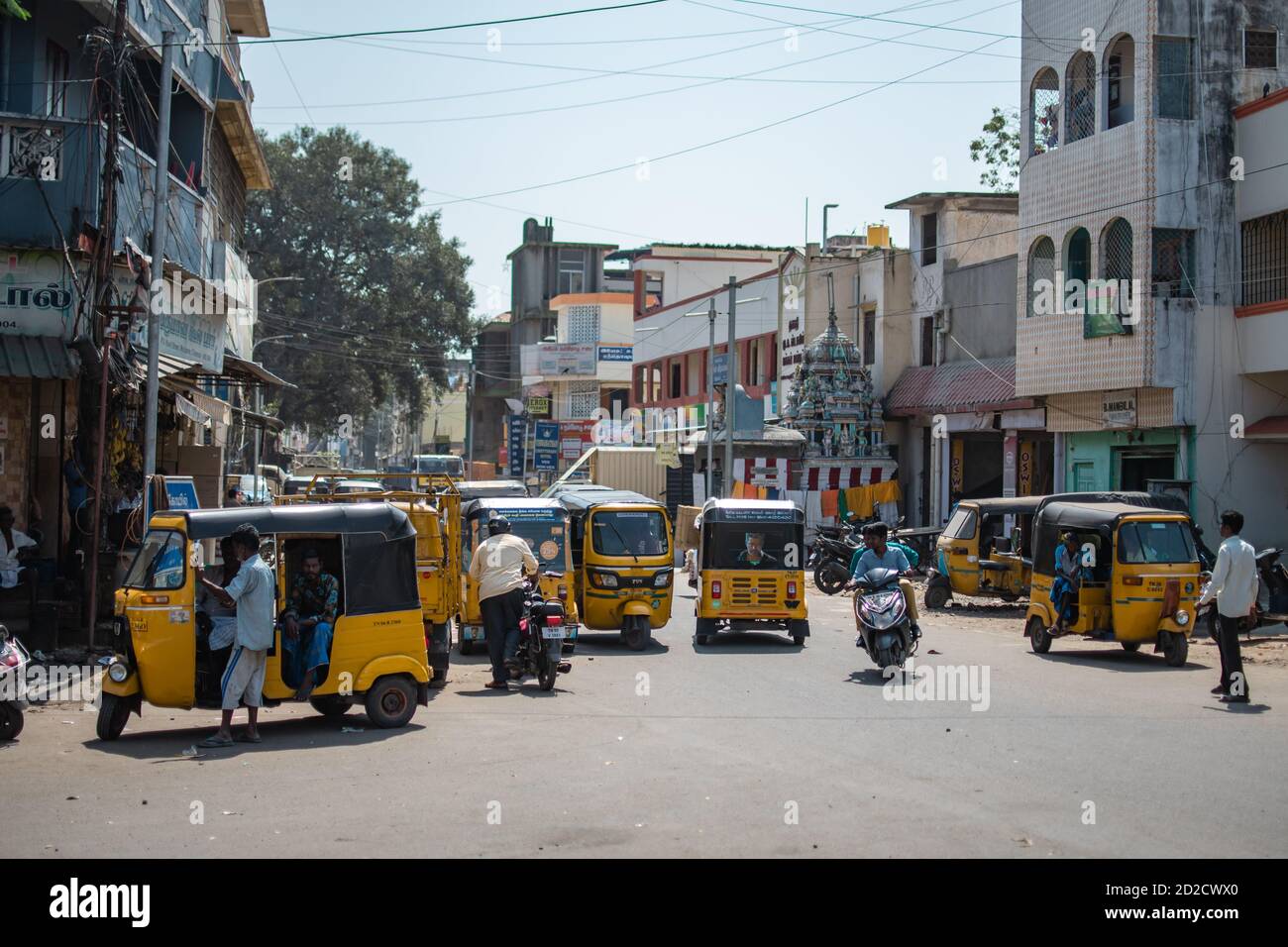 Chennai, India - February 8, 2020: Traffic with many traditional yellow taxi auto rickshaws on a street on February 8, 2020 in Chennai, India Stock Photo