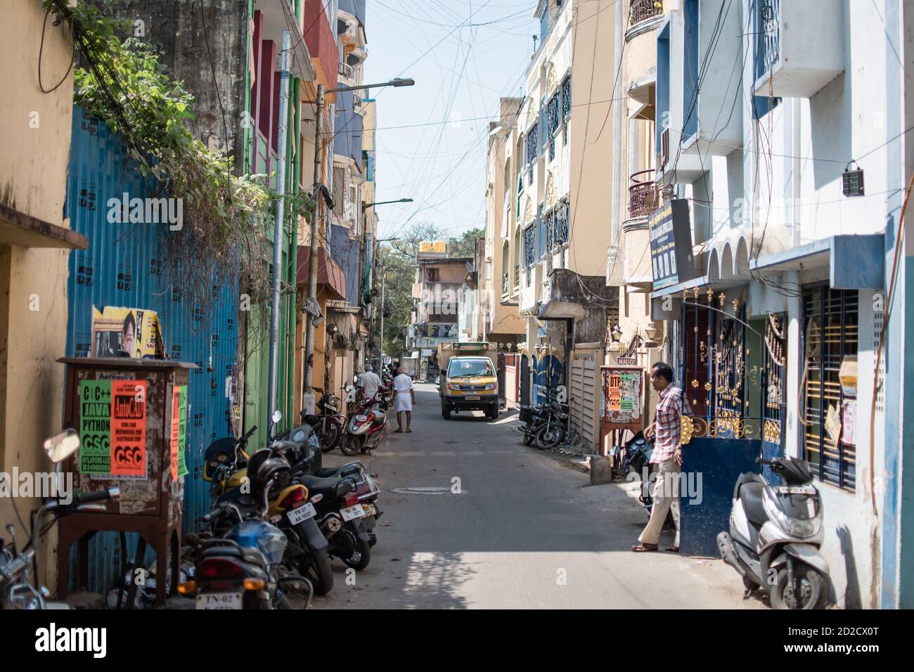 Chennai, India - February 8, 2020: Unidentified people everyday life in an alley with parked motorbikes on February 8, 2020 in Chennai, India Stock Photo