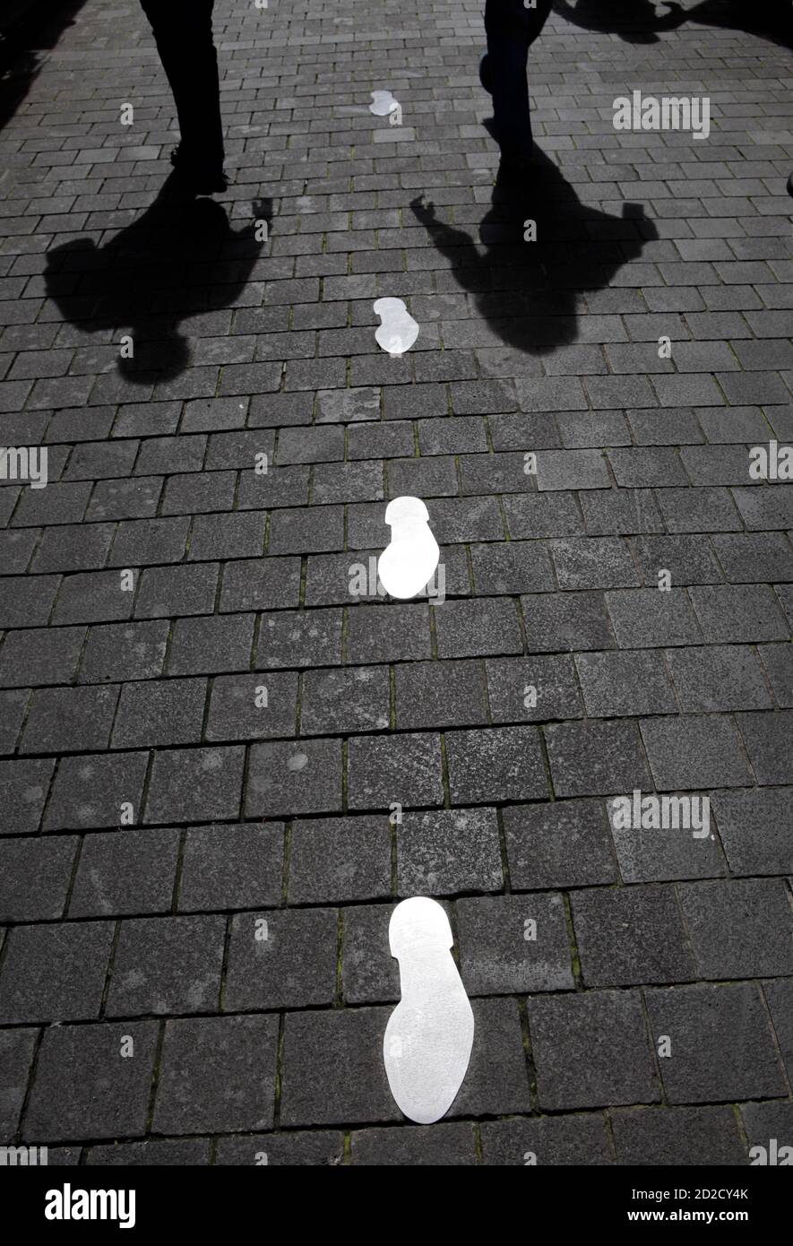 Shadows Of People Walking Are Cast On The Ground Where Replicas Of Lebanon S Assassinated Former Prime Minister Rafik Al Hariri S Footsteps Are Paved On A Route Which He Used To Take Regularly In