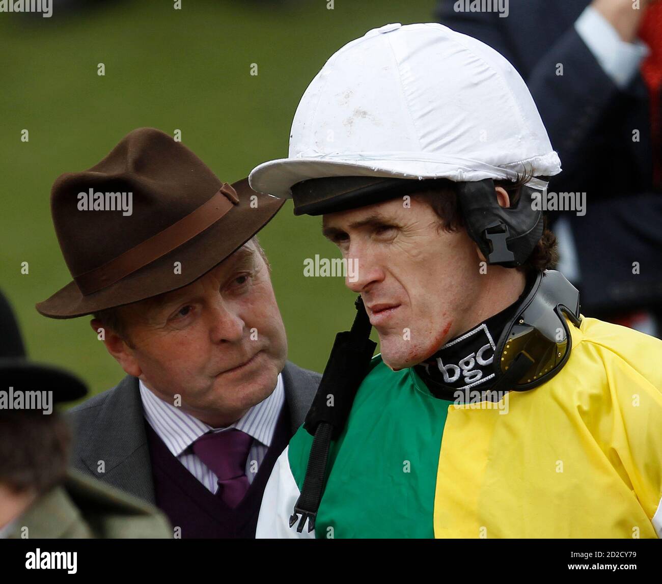 Jockey Tony McCoy (R) talks to racehorse trainer Jonjo O'Neill during The Cheltenham Festival horse racing meet in Gloucestershire, western England March 18, 2010.   REUTERS/ Eddie Keogh (BRITAIN - Tags: SPORT HORSE RACING) Stock Photo
